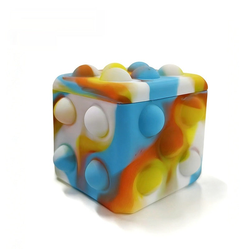 Square silicone bubble stress ball with blue and orange translucent bumps, side view
