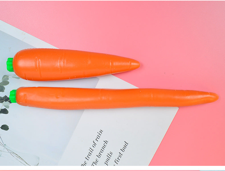 Two orange carrot-shaped stress relief toys with green caps on a card