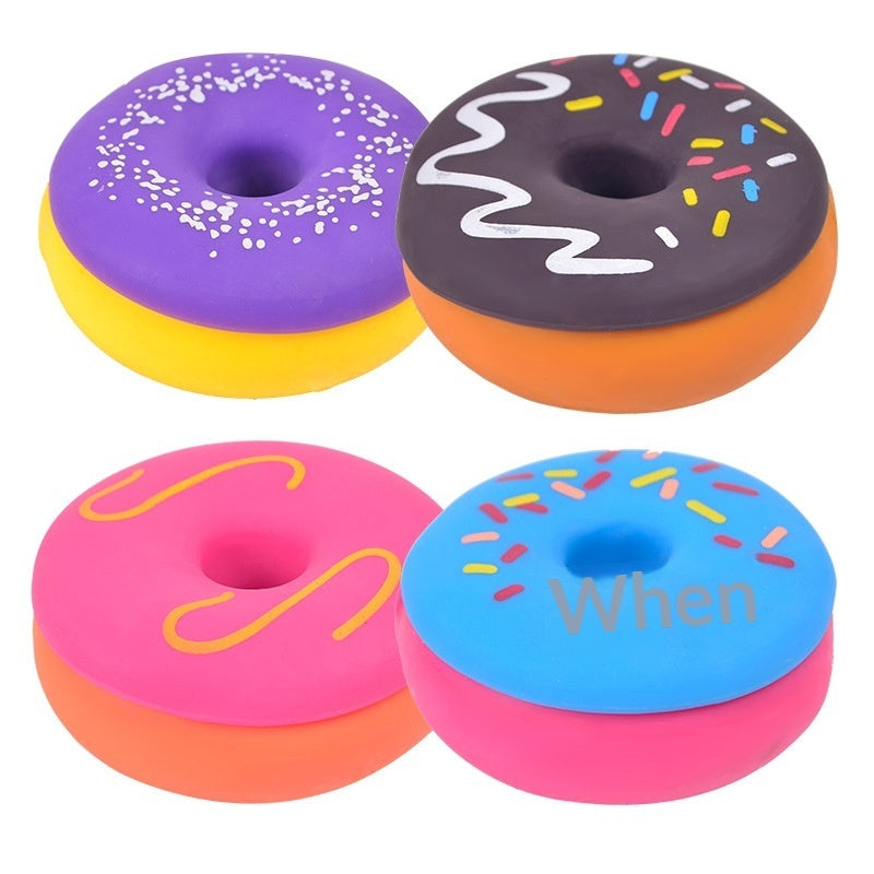 Set of squishy donut stress-relief toys, purple and black with sprinkles, pink and blue frosting donuts