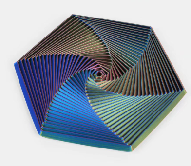 Hexagon sensory fidget toy with navy and blue spiral ridges and a small dark center.
