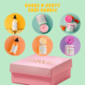 Pink care bundle box with skincare bottles, jars, and spiral soap