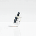 Perfume bottle with clear glass and chrome cap, standing upright