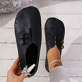 Black square-toe slip-on flats with lace-up front and gold charm buttons