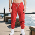 Men's red cargo jogger trousers with drawstring waist and side leg pockets
