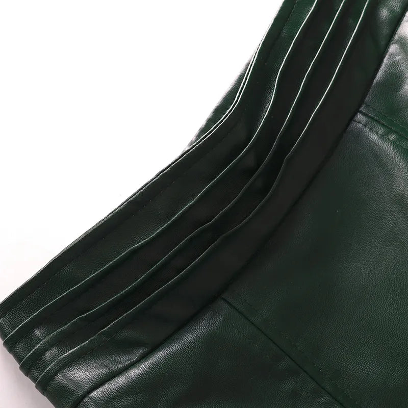 High-waist leather skirt close-up, green leather stitching along waistband