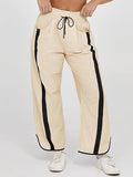 Cream wide-leg drawstring trousers with black side stripe and elastic waistband