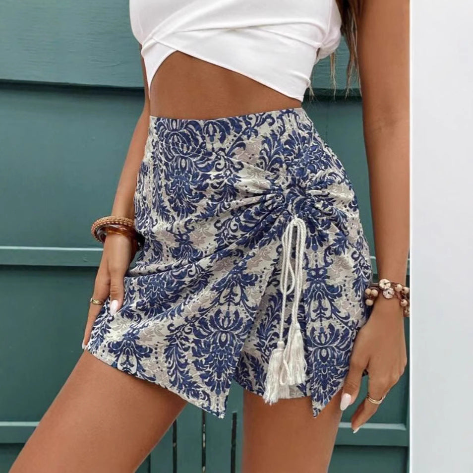 Blue and white patterned wrap shorts with gathered front and tassel tie