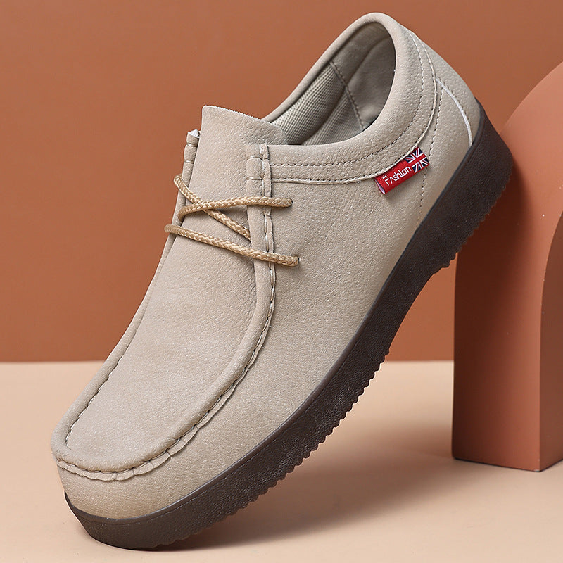 Light suede low-top lace-up loafer with dark rubber sole and moccasin-style seam detail.