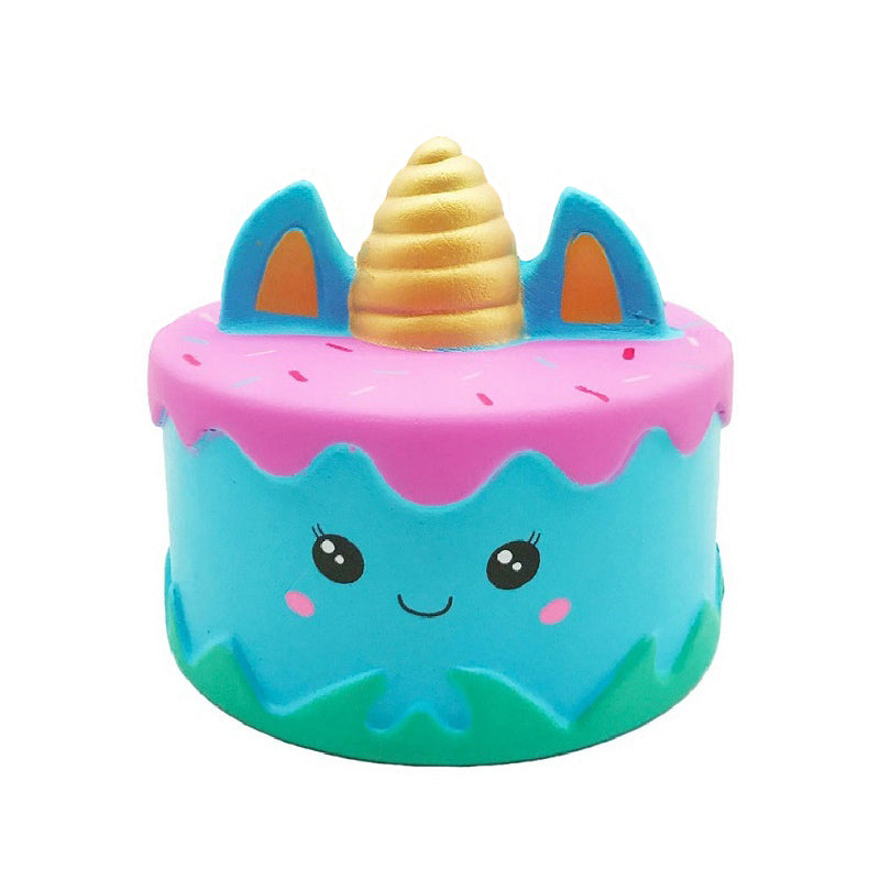 Blue and pink unicorn horn cake squishy toy with smiling face and sprinkles