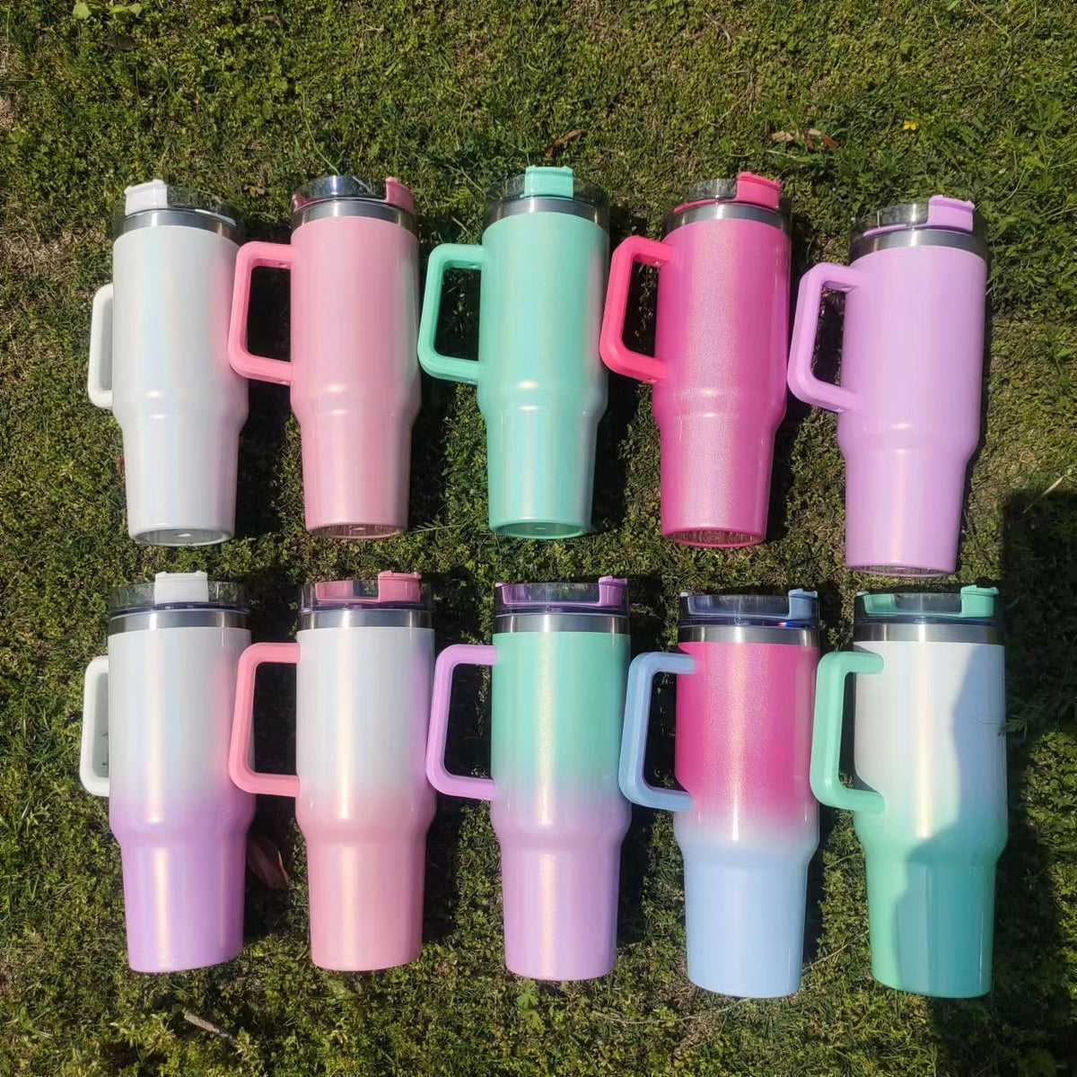 Insulated stainless steel tumbler set with rainbow gradient finishes and screw-top lids