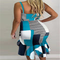 Teal-and-white halter midi dress with geometric patchwork and ruffled asymmetrical hem