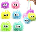 Set of small spiky fuzzy ball keychains with round eyes in pastel rainbow colors