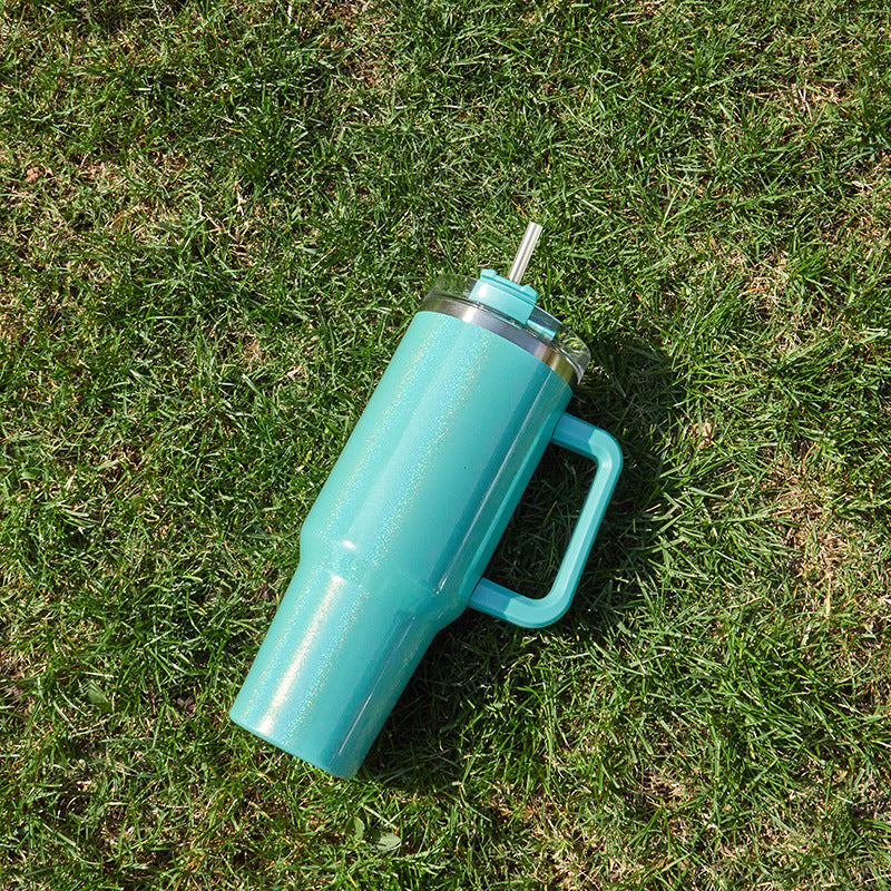 Large insulated stainless steel tumbler, teal-blue finish with clear lid and straw, side handle