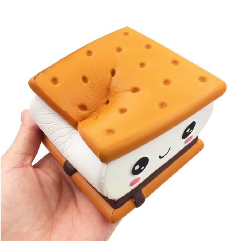 Hand holding plush sandwich biscuit toy with panda face and orange crimped edges