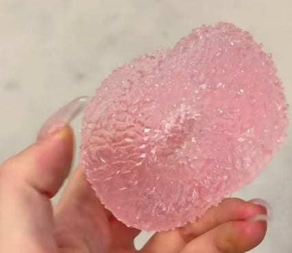 Pink textured bayberry-shaped squishy stress toy with stem, close-up
