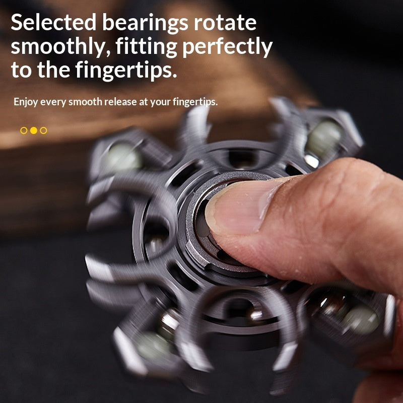 Silver metal fidget spinner with central bearing, fingers adjusting the arms