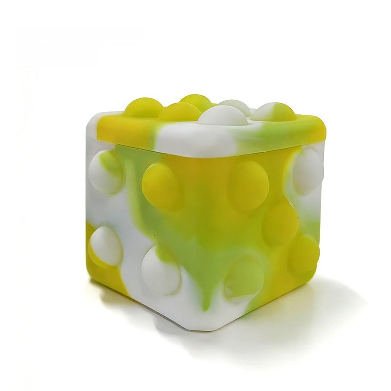 Square silicone bubble stress ball with green and white translucent bumps, angled view