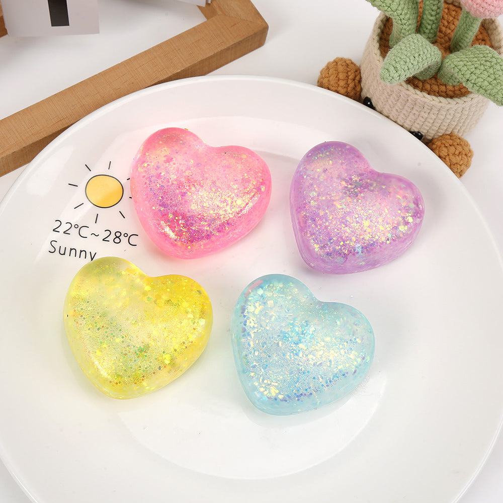 Glitter heart squeeze stress toy set in pink, purple, yellow, and blue