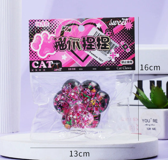 Pink and purple glitter cat paw stress toy in clear blister pack