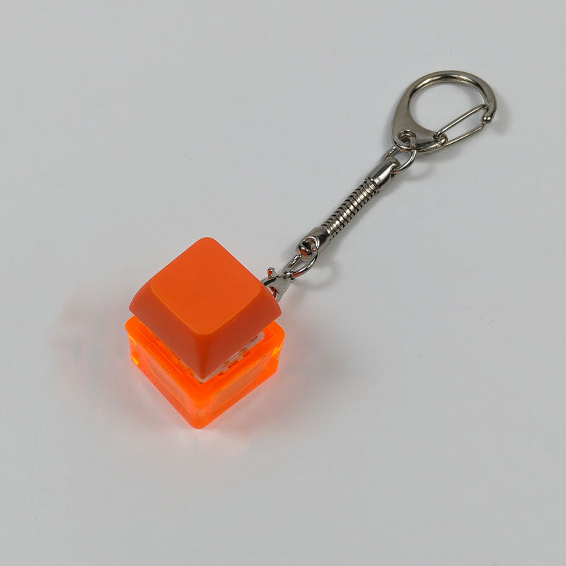 Orange square finger-popping stress-relief keychain toy with metal chain and rings