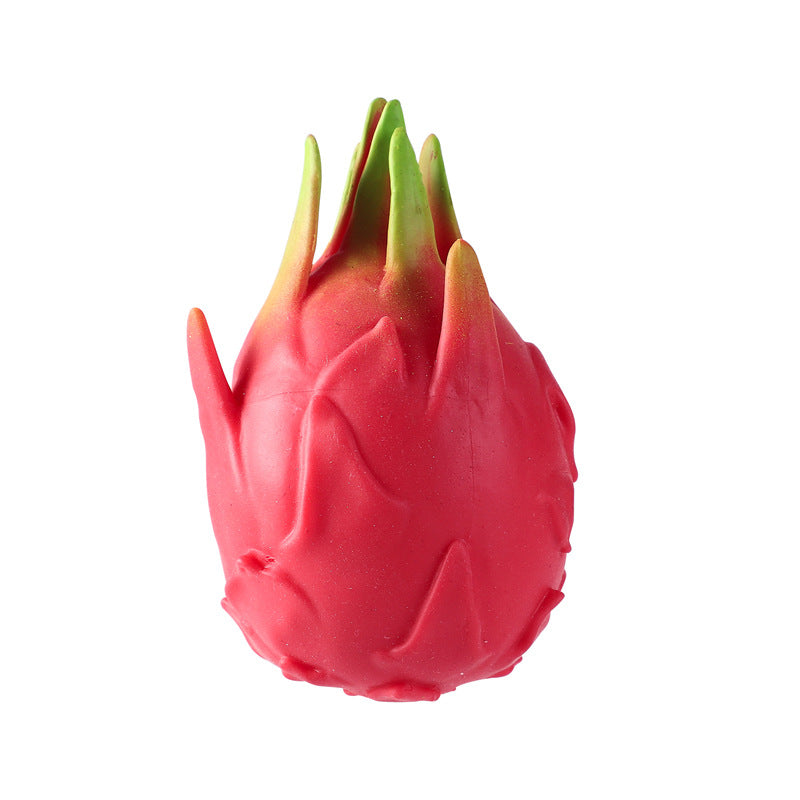 Close-up red dragon fruit stress-relief gag toy with green leafy top