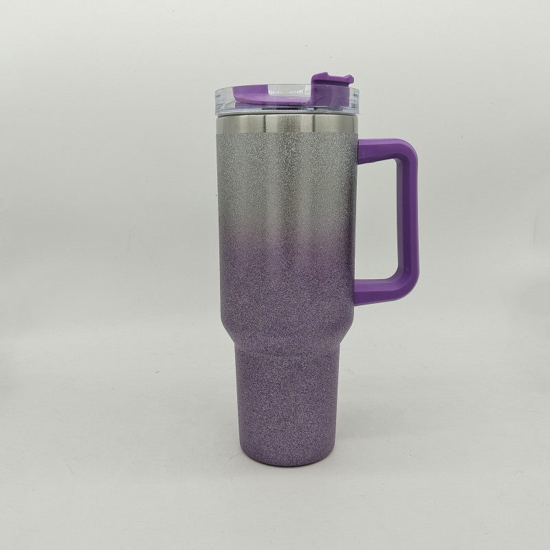 Insulated stainless steel tumbler with purple-to-gray gradient finish, handle, and clear lid