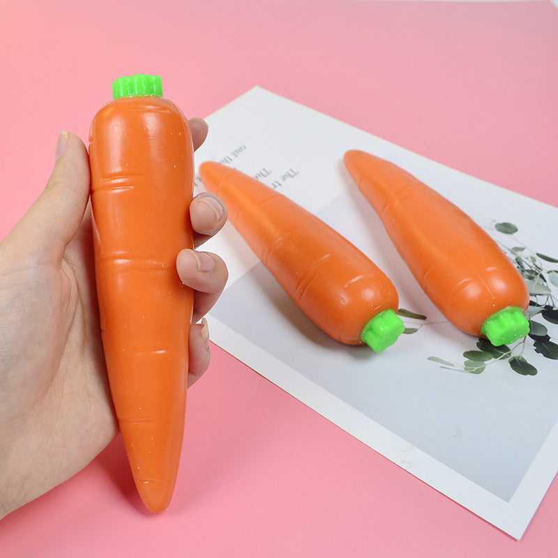 Orange carrot-shaped stress relief toy with a small green cap on top