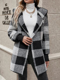 Black and white plaid knit cardigan with open front, long sleeves, and notched lapels