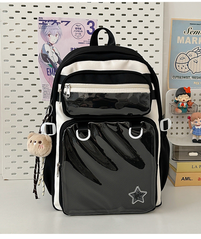 Black nylon backpack with front zip pocket, mesh panel, and star patch