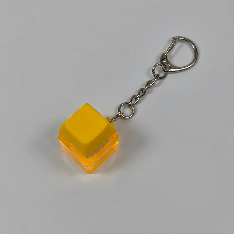 Yellow square finger-popping stress-relief keychain toy with metal chain and rings
