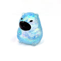 Blue capybara-shaped squishy candy stress toy, glittery translucent body with black face