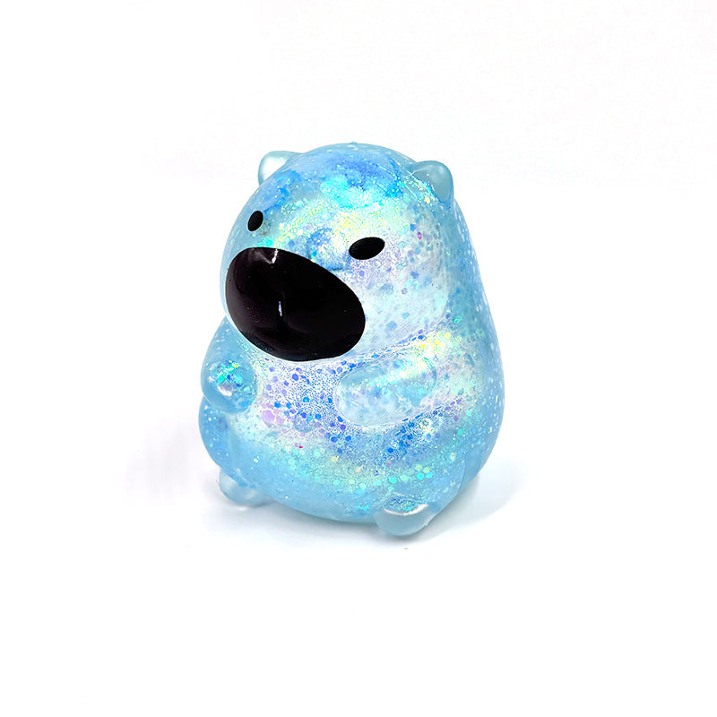 Blue capybara-shaped squishy candy stress toy, glittery translucent body with black face