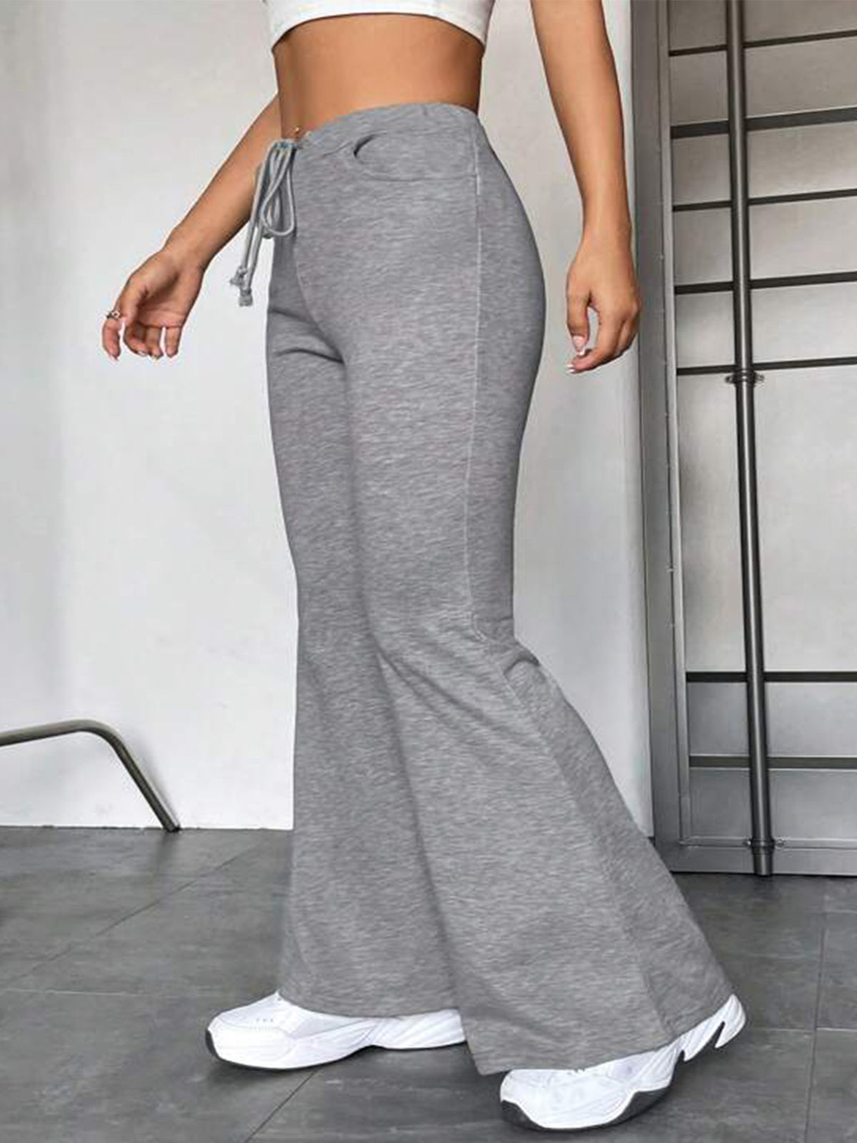 Gray flared lounge pants with drawstring waist and wide bell bottom.