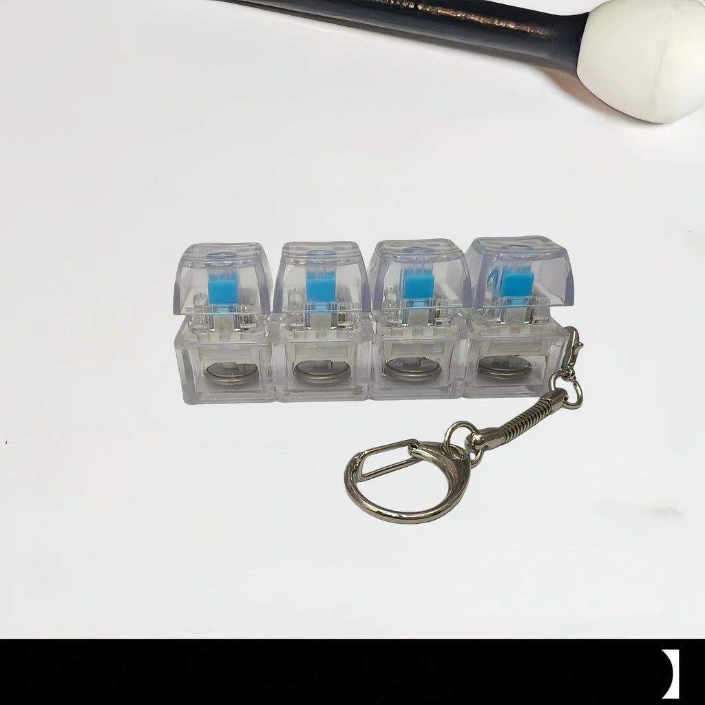 Clear mini keyboard keycap keychain with blue-lit switches and keyring spring clip