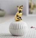 White ribbed jewelry box with gold cat figurine lid