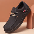 Dark suede low-top lace-up loafer with contrast eyelets, dark rubber sole, moc stitching.