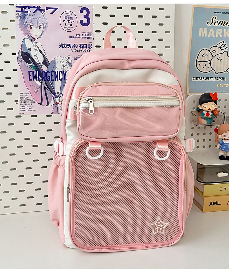 Pink large capacity nylon backpack with front zip pocket, mesh panel, and star badge