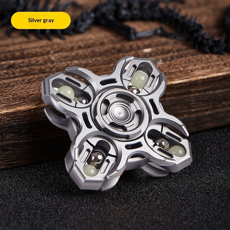 Silver gray aluminum fidget spinner with central disc and three claw-like arms