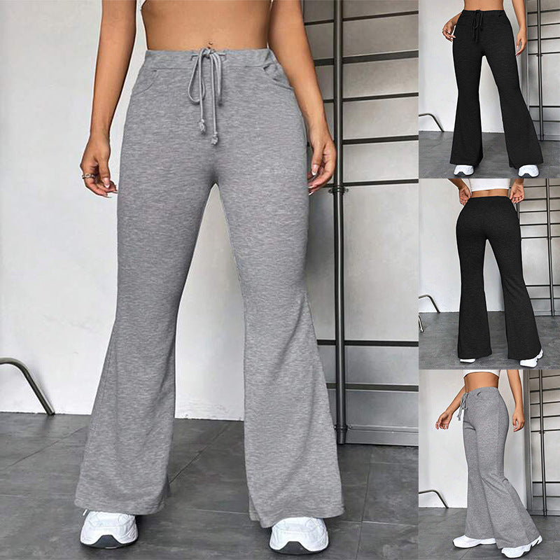 Gray flared yoga pants with drawstring elastic waistband, full-length.