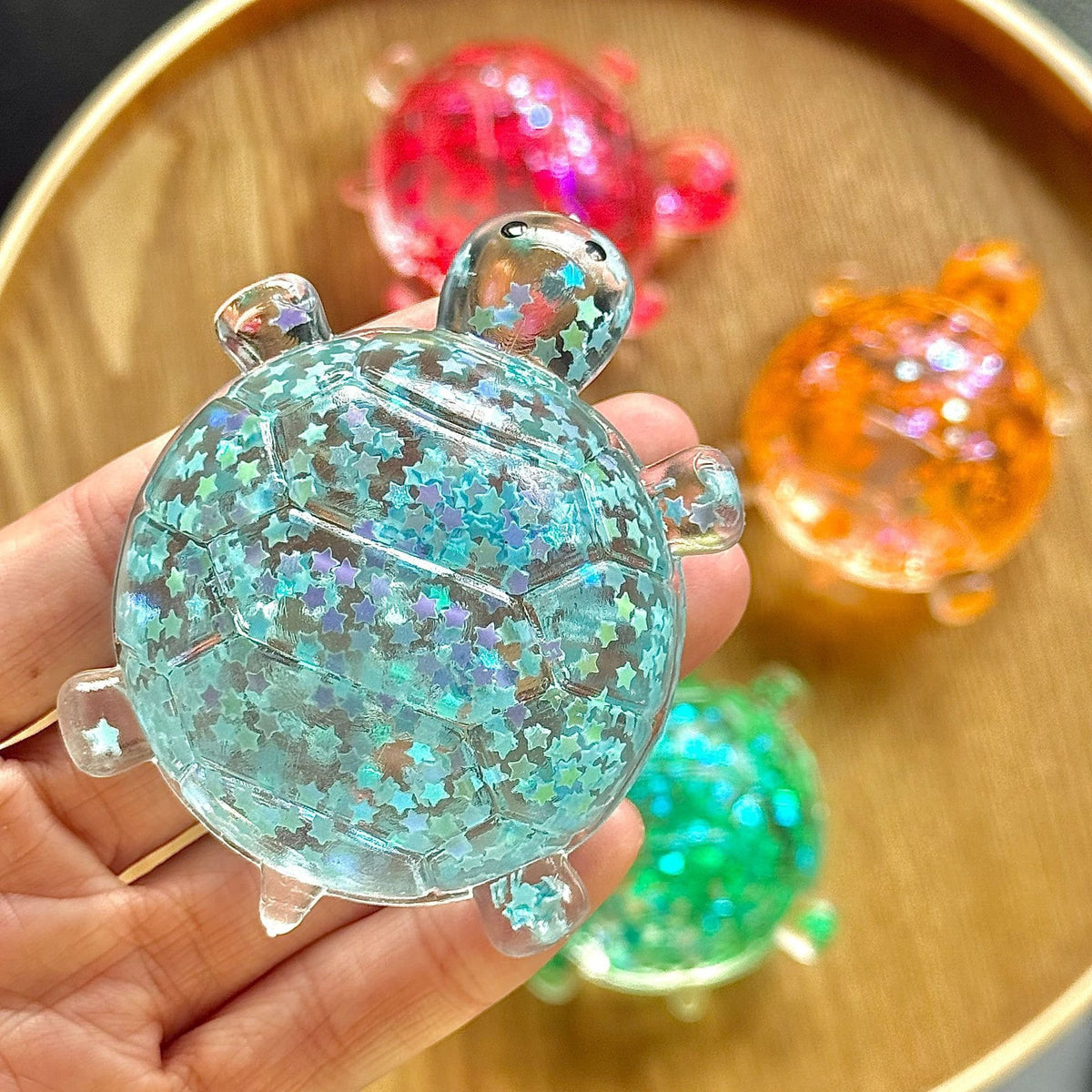 Blue glitter bubble-bead sea star stress toy, slow-rebound, handheld close-up