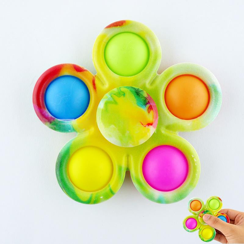 Lime green fidget spinner with six rainbow tie-dye button tips and central green disc.
