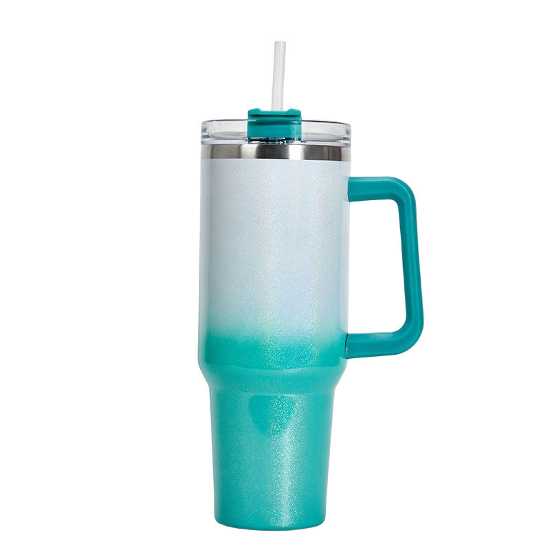 Insulated stainless steel tumbler with white-to-teal gradient finish, handle, and clear lid