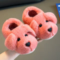 Pink plush animal-face slippers with rounded ears and dark nose, open heel