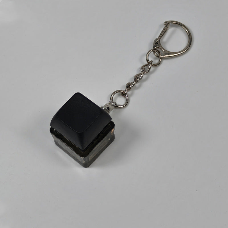 Black square finger-popping stress-relief keychain toy with metal chain and rings