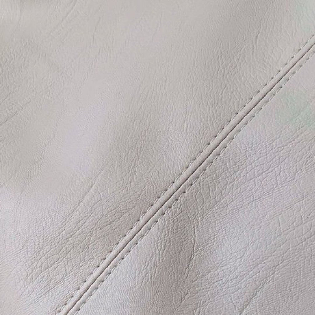 Ivory pebbled leather texture with visible stitched seam on shoulder bag