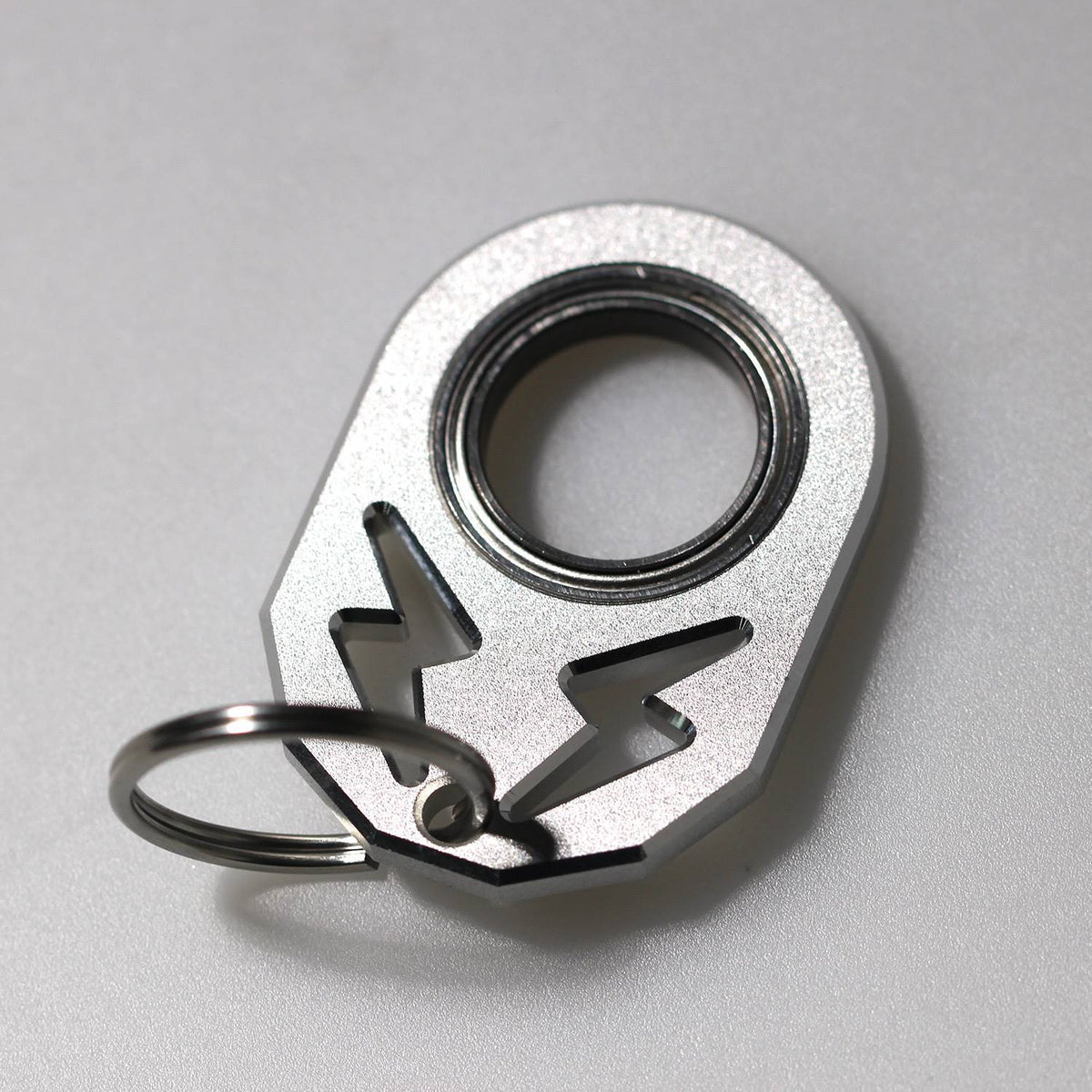 Silver rotating key chain with black inner ring and hook, no label.