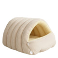 Beige corduroy-style enclosed pet sleeping nest with curved tunnel entrance and padded floor.