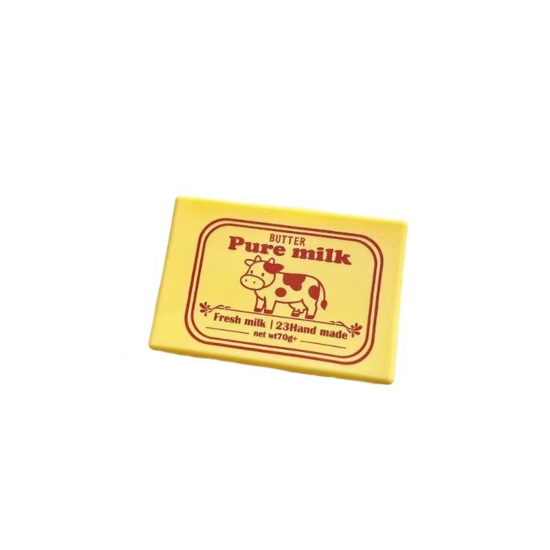 Yellow cube squeeze toy with “Pure milk” label and cow illustration