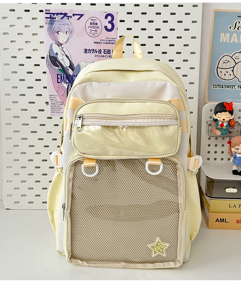Light yellow large capacity nylon backpack with front zip pocket, mesh panel, and star badge