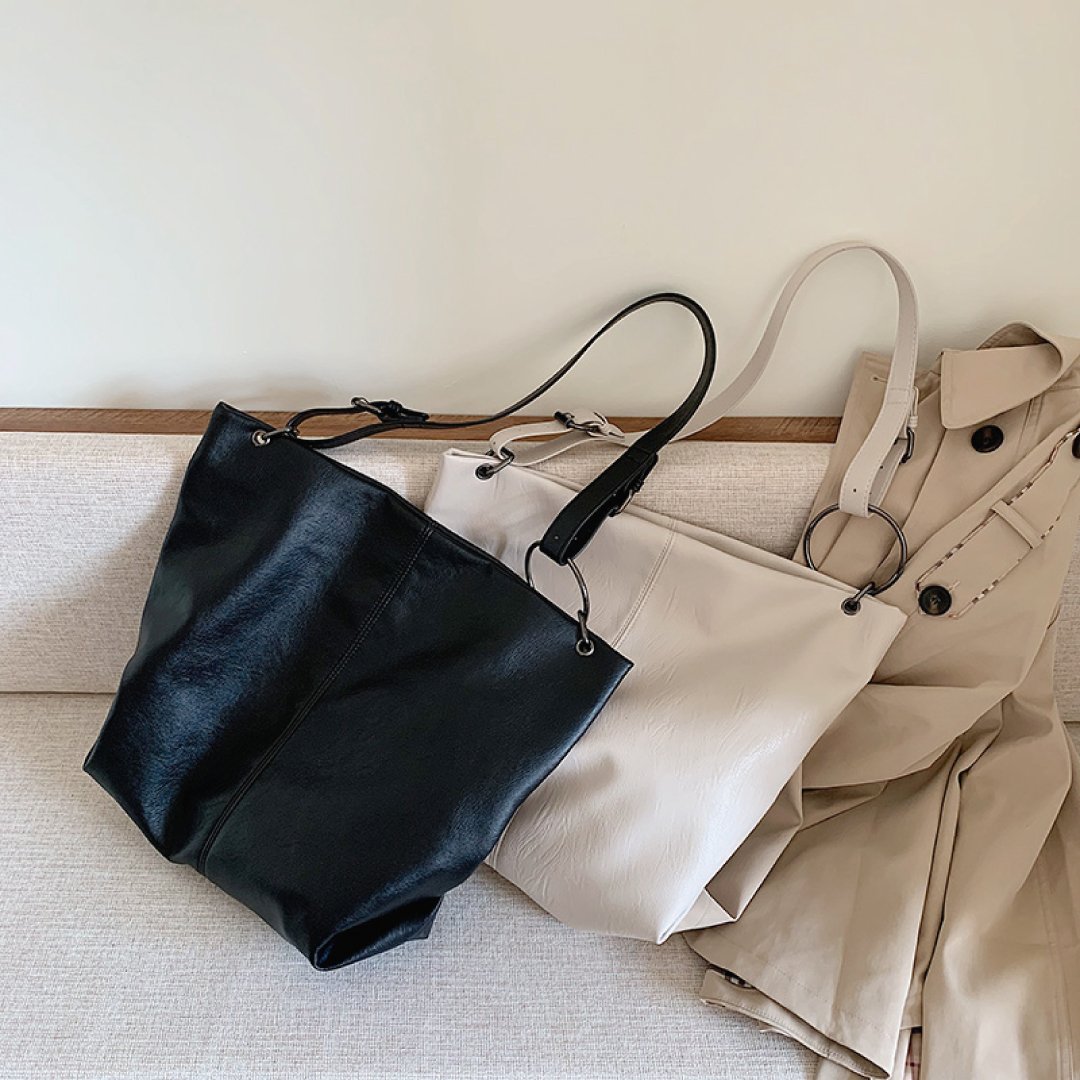 Black and ivory shoulder bags with ring handles, slouchy hobo silhouettes